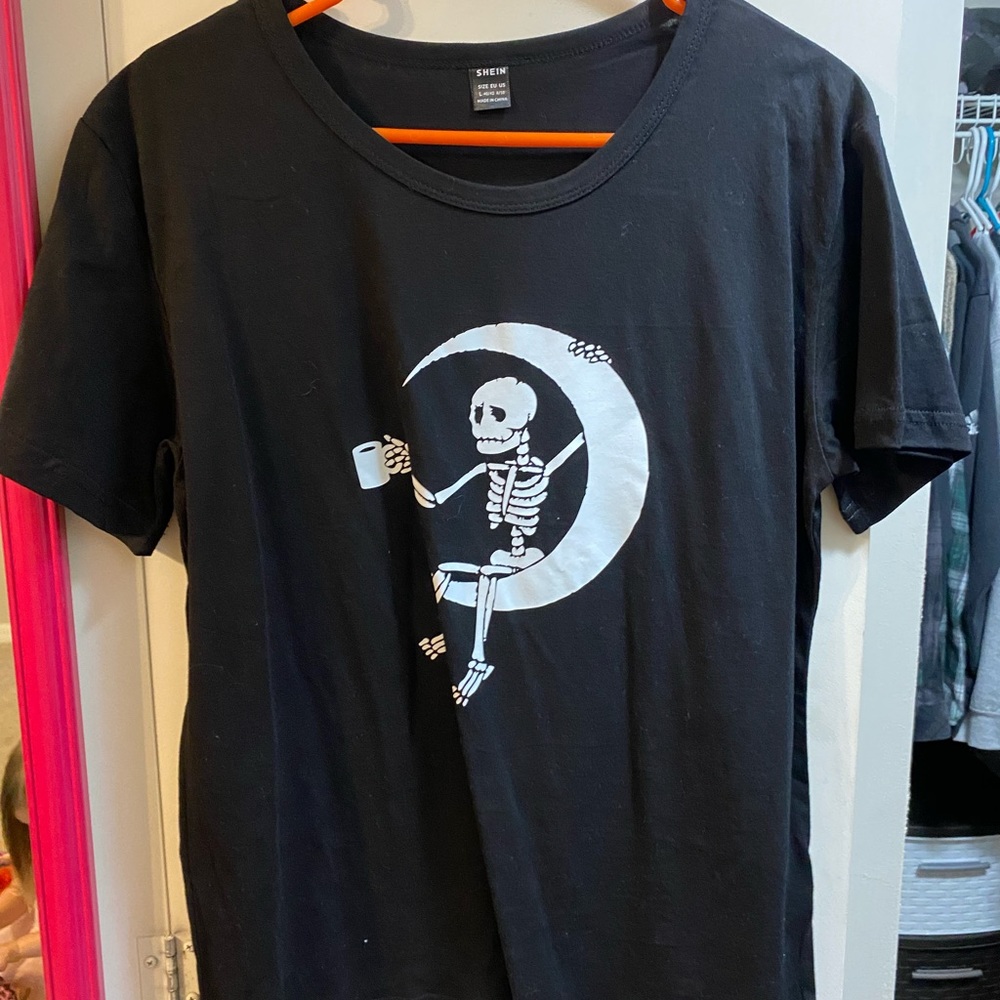 Skeleton drinking coffee on a moon graphic tee